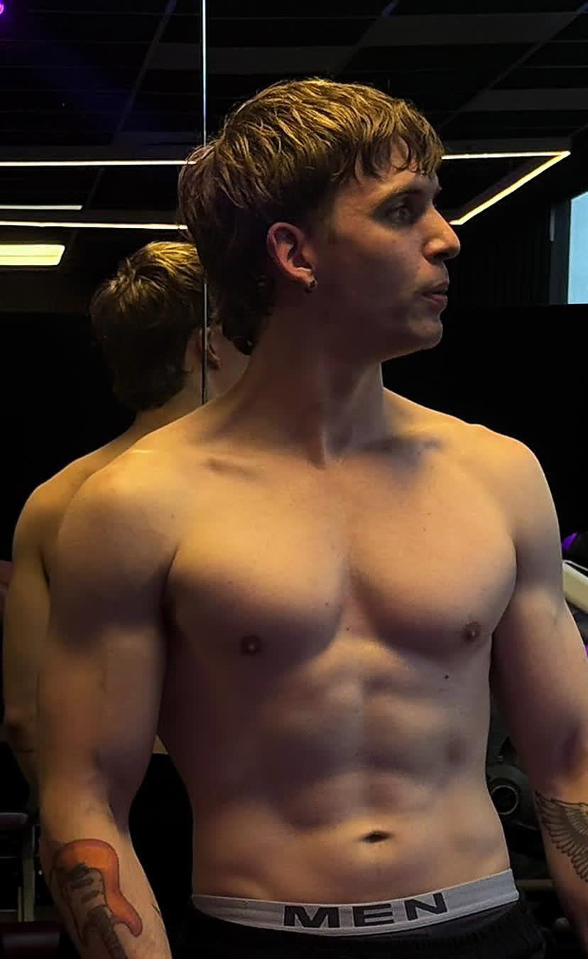 Rolo after, standing in a gym, visibly leaner